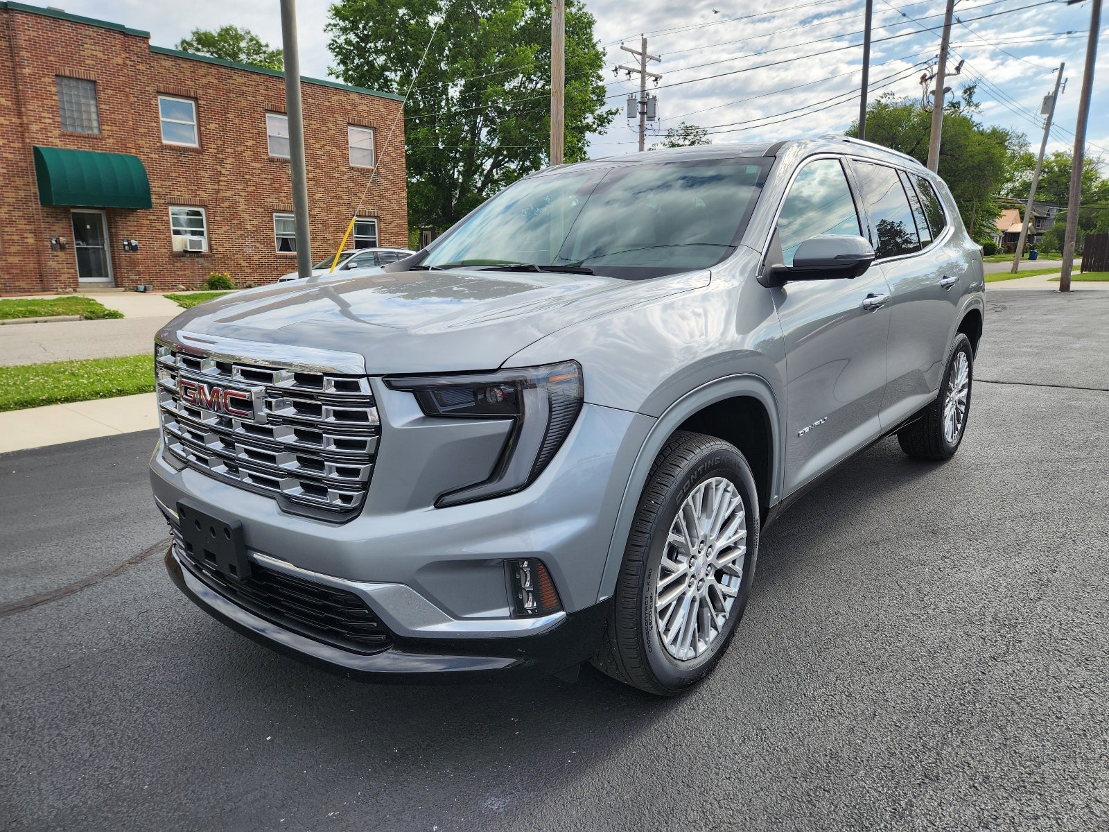 2024 GMC Acadia Denali in Sterling Metallic — front three-quarter view