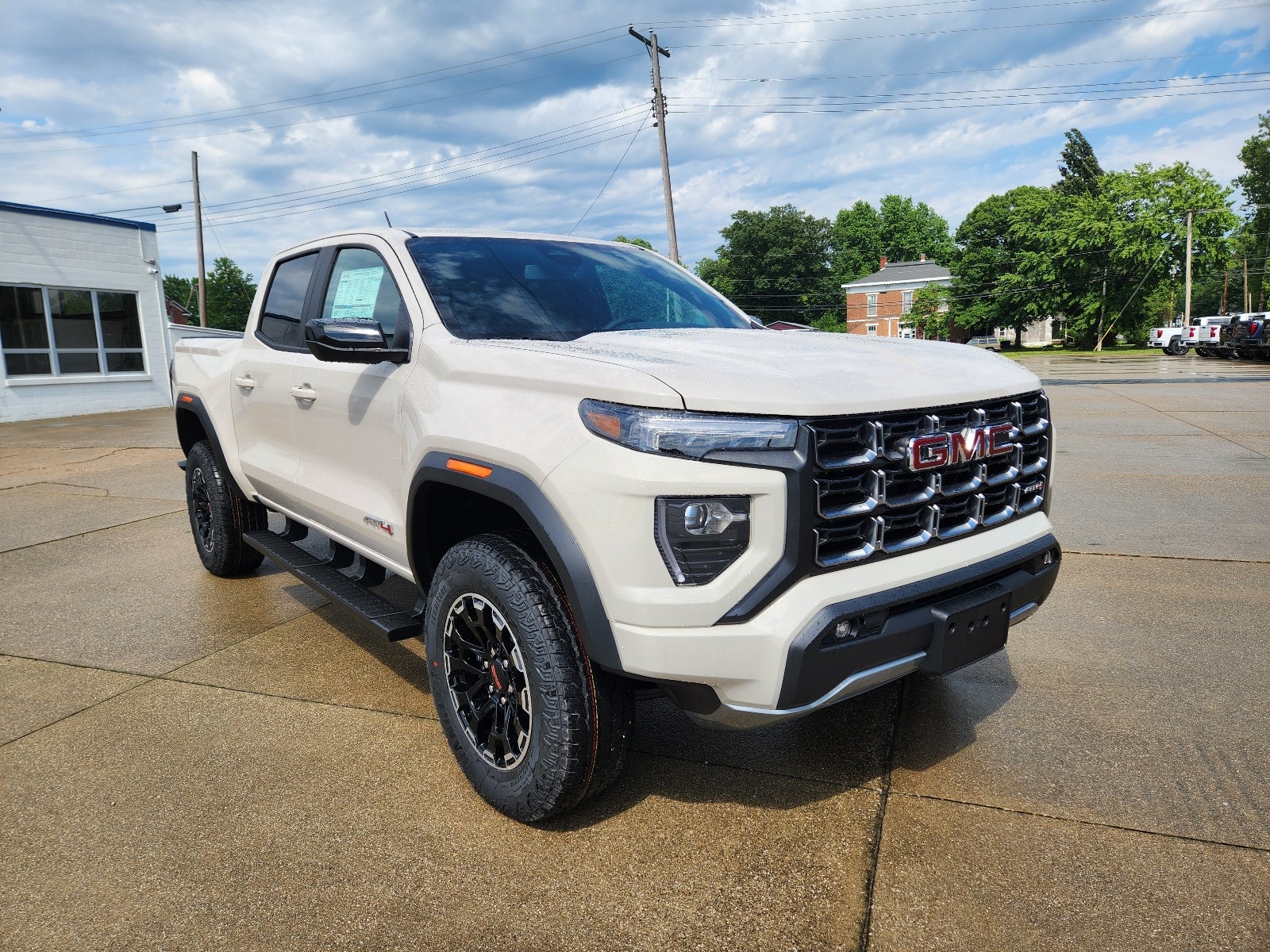 2026 GMC Canyon AT4 in Coastal Dune — front three-quarter view