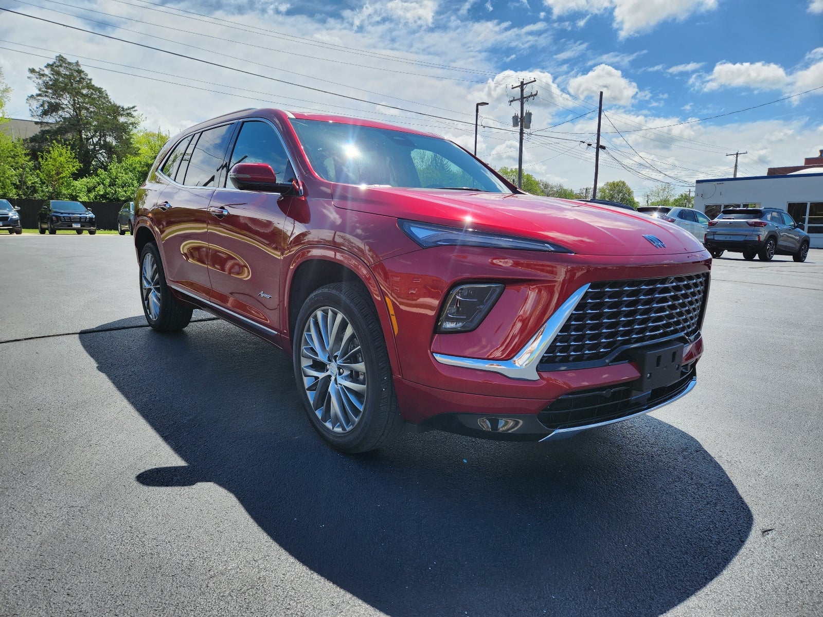 2025 Buick Enclave Avenir in Cherry Red Tintcoat — front three-quarter view