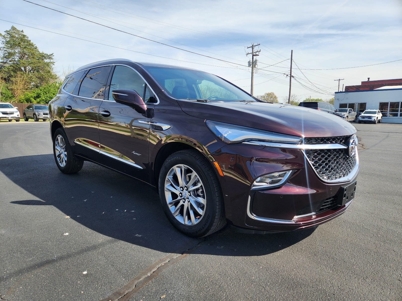 2023 Buick Enclave Avenir in Rich Garnet Metallic — front three-quarter view